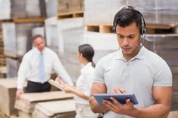 Female manager using digital tablet in warehouse, warehouse inventory management software