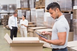 Portrait of male manager using digital tablet in warehouse_distribution software